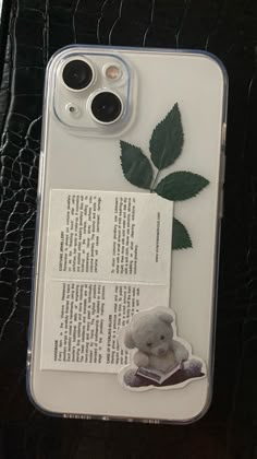 a cell phone case with an image of a teddy bear and leaf on the back