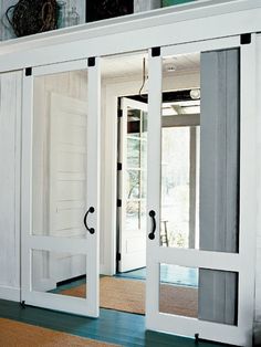 the inside of a house with white doors and windows