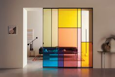 a room that has some colorful glass doors on the door and a table in front of it