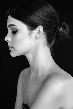 black and white photograph of a woman with her hair in a high bun updo