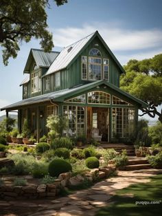 a large green house sitting on top of a lush green field