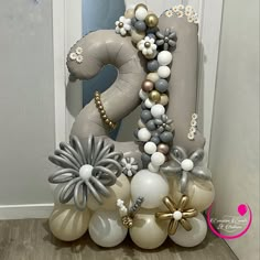 a number decorated with balloons in the shape of flowers