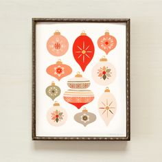 a framed christmas ornament art piece hanging on a wall