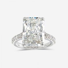 an engagement ring with a cushion cut diamond in the center and pave set shoulders