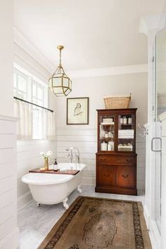 a bathroom with a rug, sink and bathtub