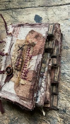 an old book is covered in fabric and beads