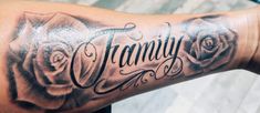 a woman's arm with the word family written on it and roses in black ink