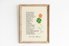 a framed print with a poem and four leaf clovers