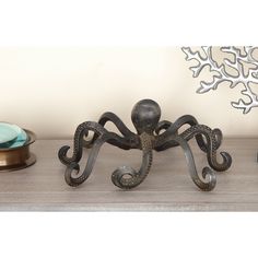 an octopus figurine sitting on top of a wooden table next to other items