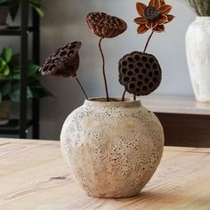 a vase with some flowers in it on a table