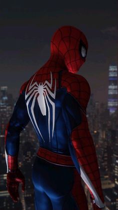 the amazing spider - man is standing in front of a cityscape at night