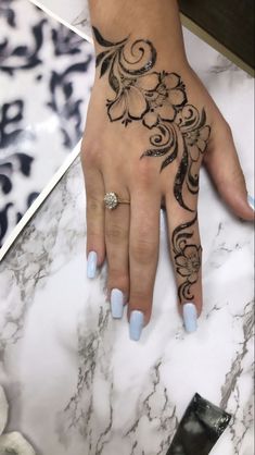 a woman's hand with a tattoo on it