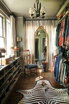 a room filled with lots of clothes and furniture