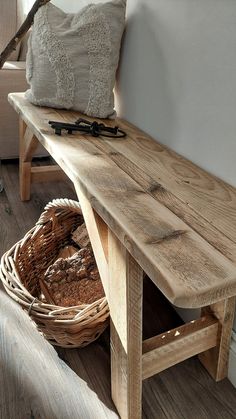 a wooden bench sitting next to a basket