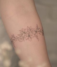 a woman's arm with flowers on it