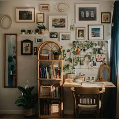 a room with many pictures on the wall and a wooden desk in front of it