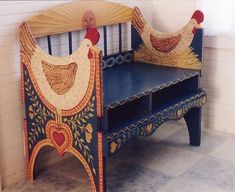 two wooden benches made to look like chickens and roosters with hearts painted on them