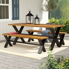 a picnic table with benches and lanterns on it