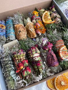 a box filled with lots of different types of flowers and fruit wrapped in twine