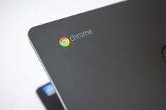 the chrome logo is displayed on the back of a laptop