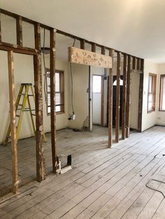 an empty room with wooden floors and walls being built in the process of remodeling