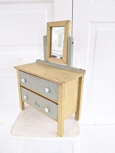 an old dresser with a mirror on top