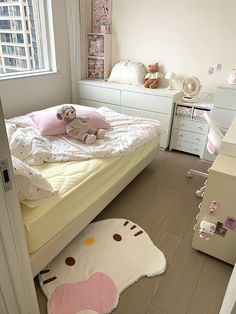 a small child's bedroom with a hello kitty bed