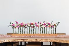 flowers are arranged in vases on top of a table with pink and white decor