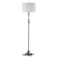 a floor lamp with a white shade on it