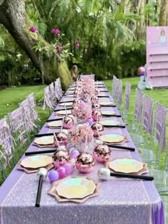 a long table with purple and pink decorations