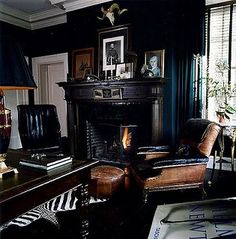 a living room filled with furniture and a fire place next to a window covered in curtains