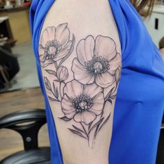 a woman's arm with three flowers on it