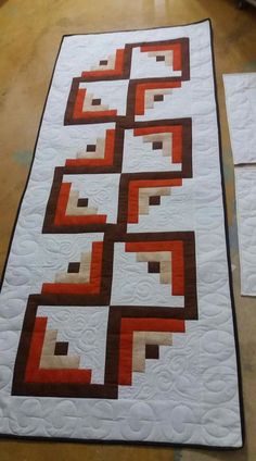 two quilts are laying on the floor next to each other and one is made with squares