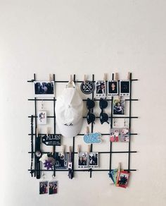 a white wall with several pictures hanging on it