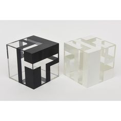 two black and white cubes sitting next to each other on top of a table