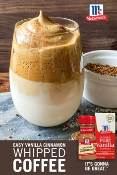 a glass jar filled with whipped coffee next to some cereal