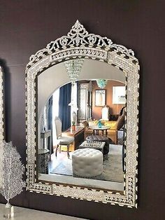 a living room with a large mirror on the wall