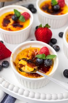 small bowls filled with fruit and oatmeal on top of a white plate