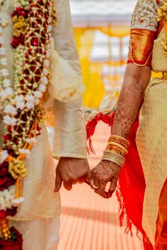 the bride and groom are holding hands