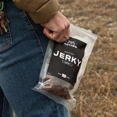 a person holding a bag of food in their left hand while standing on the ground