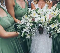 the bride and her bridesmaids are holding their bouquets