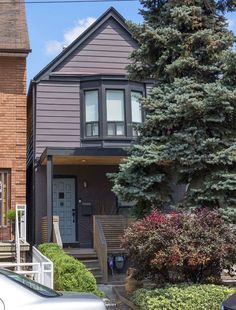 two houses with cars parked in front of them