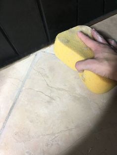 a person is cleaning the floor with a sponge