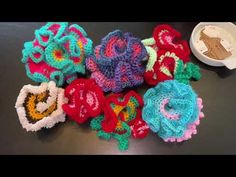 several crocheted flowers sitting on top of a table