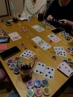 two women sitting at a table playing cards