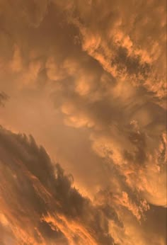 an airplane is flying in the sky at sunset or dawn with some clouds behind it