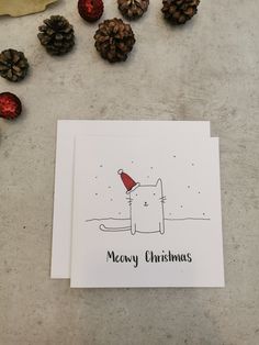 a christmas card with a cat wearing a santa hat and the words merry christmas written on it