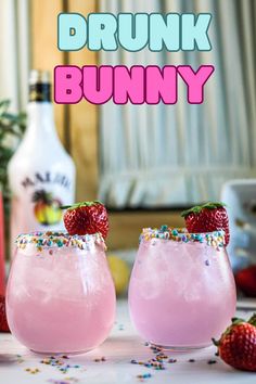 two glasses filled with pink liquid and topped with sprinkles