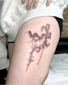 a woman with a tattoo on her thigh