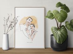 a couple's portrait is displayed on a shelf next to a potted plant